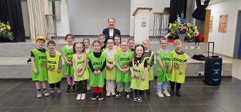 Group of children wearing Street Stuff bibs at the school holiday camp in Linwood with Councillor Marie McGurk