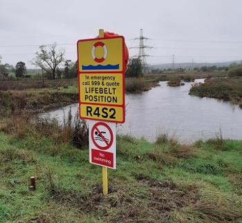 A water safety sign showing the GPS code on the Clay Pit riverbank