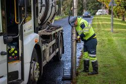 Image of council employee clearing drains