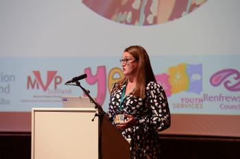 Nicola Sykes stands at a podium talking.
