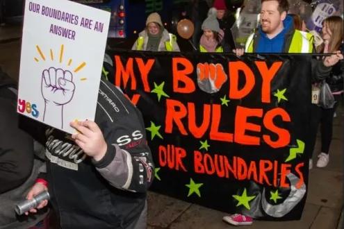 People holding signs at a 'Reclaim the night' march