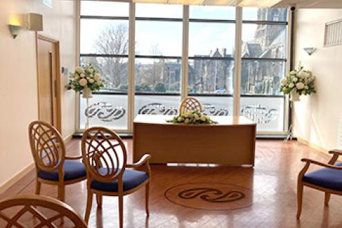 The Paisley wedding suite showing the couple's chairs at the front left of the registrar's desk and another chair on the right.