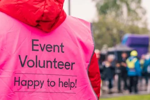 Event volunteer working at event with pink high vis jacket on