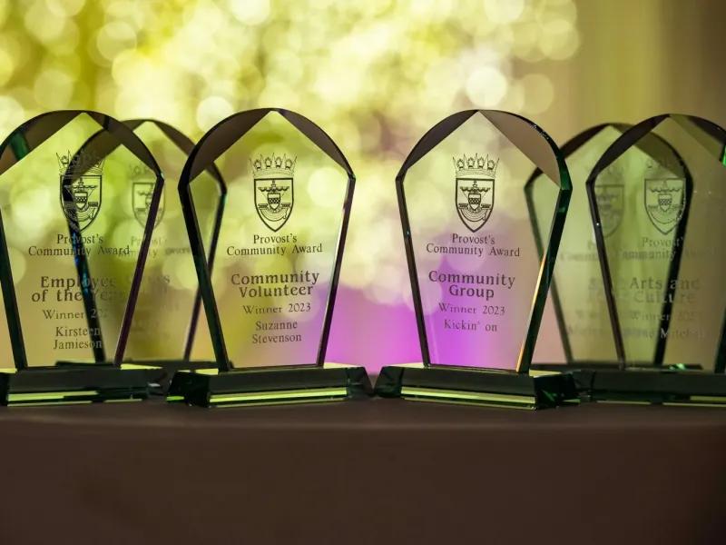 Five clear glass awards for community contributions, including Employee of the Year, Volunteer, Group, Arts and Culture and Sport categories.