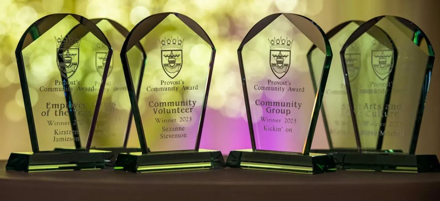 Five clear glass awards for community contributions, including Employee of the Year, Volunteer, Group, Arts and Culture and Sport categories.
