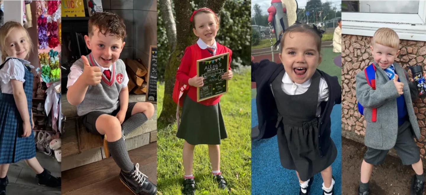 Seven primary 1 pupils smile on their first day.