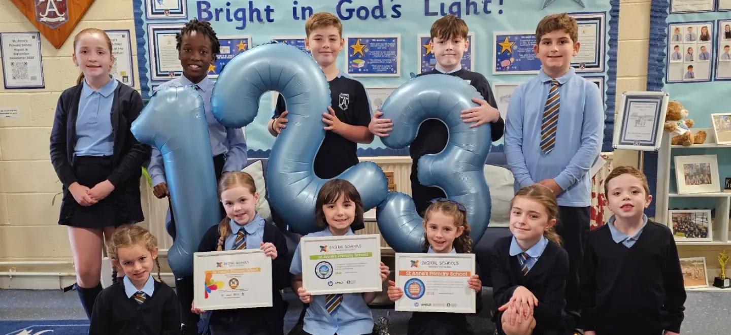 Children holding balloons shaped as numbers and three certificates.