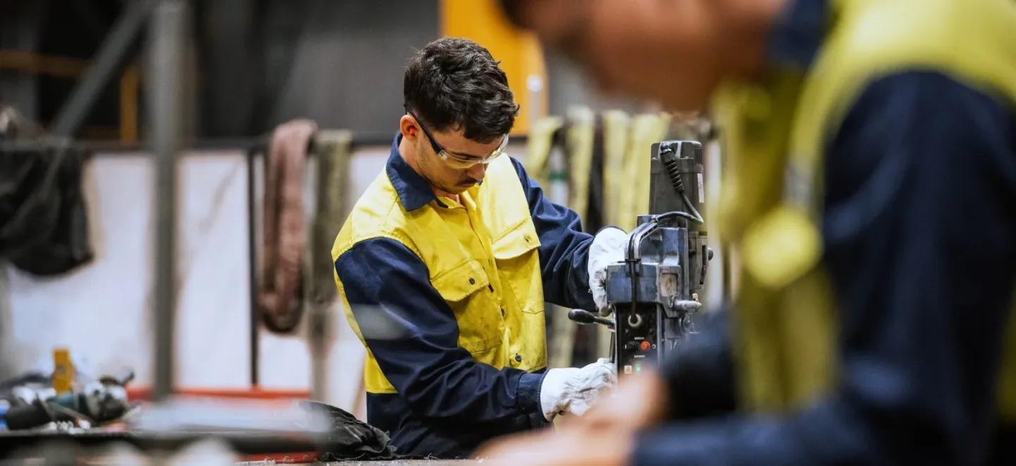 Two men in a fabrication factory